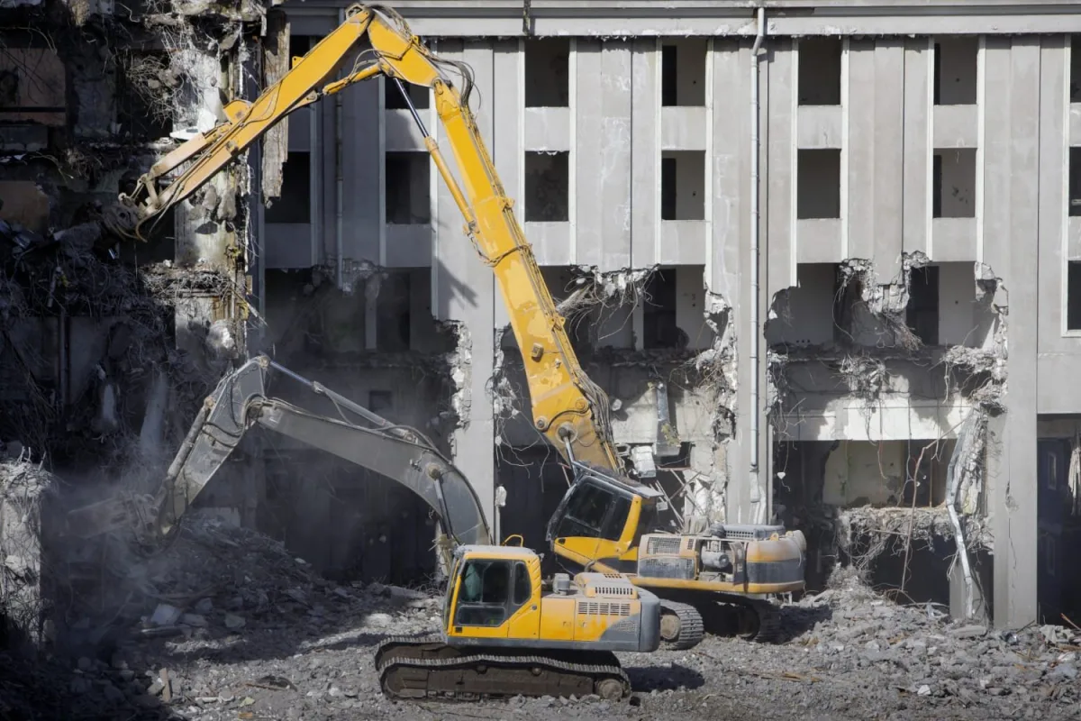 Demolition excavator working through a multi-story structure